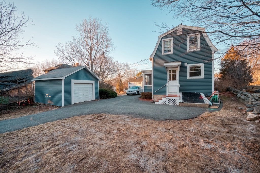 87 Conant Street Danvers, MA 01923 - Photo 30 of 31 a front view of a house with a yard and garage