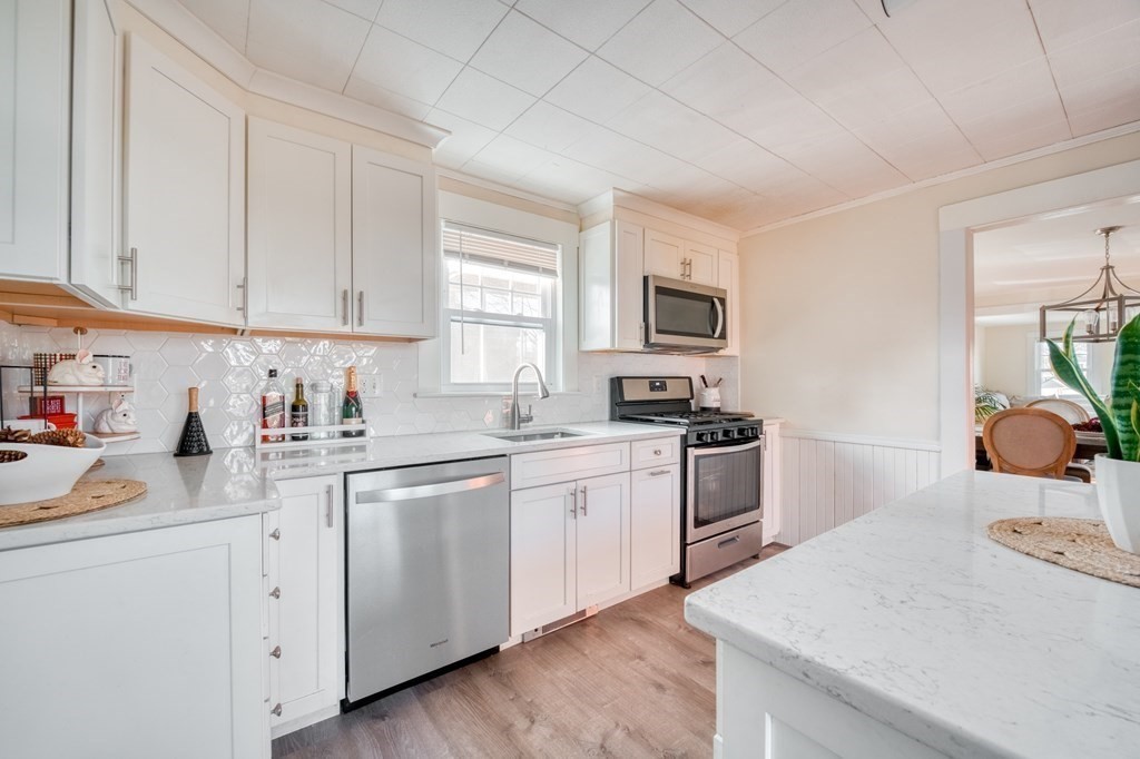 87 Conant Street Danvers, MA 01923 - Photo 4 of 31 a kitchen with cabinets appliances a sink and a window