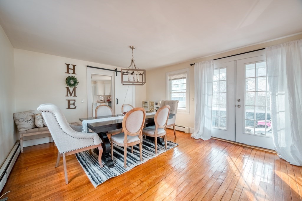 87 Conant Street Danvers, MA 01923 - Photo 5 of 31 a dining room with wooden floor and chandelier