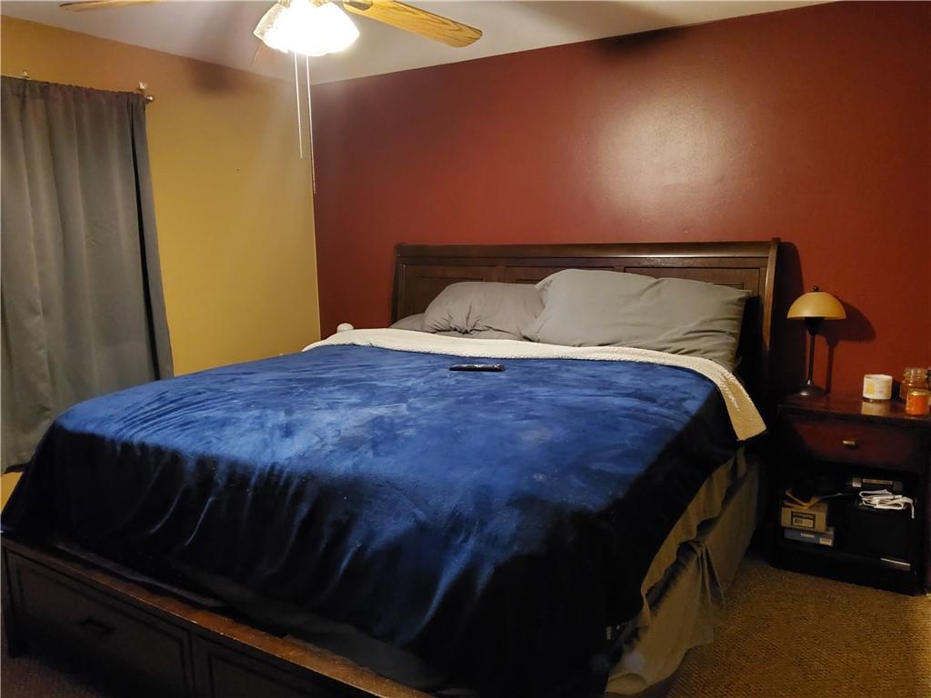 105 Fredonia Road Mercer, PA 16137 - Photo 6 of 11 a bed sitting in a bedroom next to a lamp