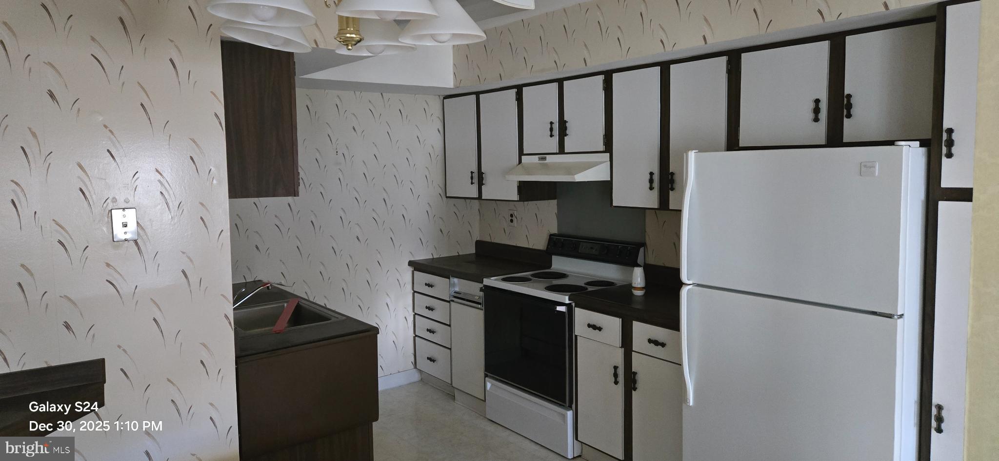 115 East Kings Highway, Unit 211 Maple Shade, NJ 08052 - Photo 6 of 10 a kitchen with a refrigerator and a stove