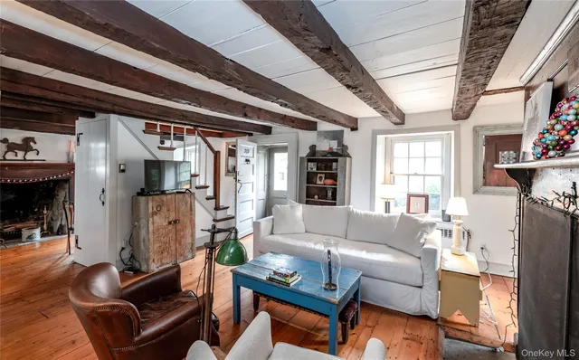 a living room with furniture a fireplace and a window