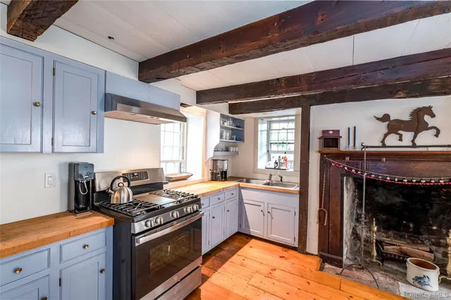 a kitchen with stainless steel appliances granite countertop a sink stove and cabinets