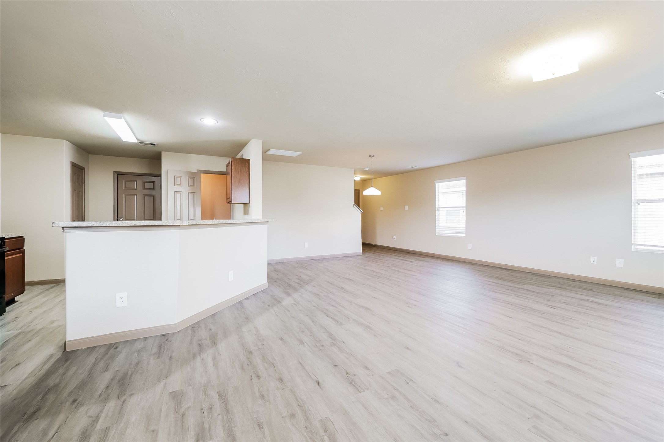 2410 Connors Path Court Houston, TX 77073 - Photo 5 of 12 an empty room with wooden floor and windows