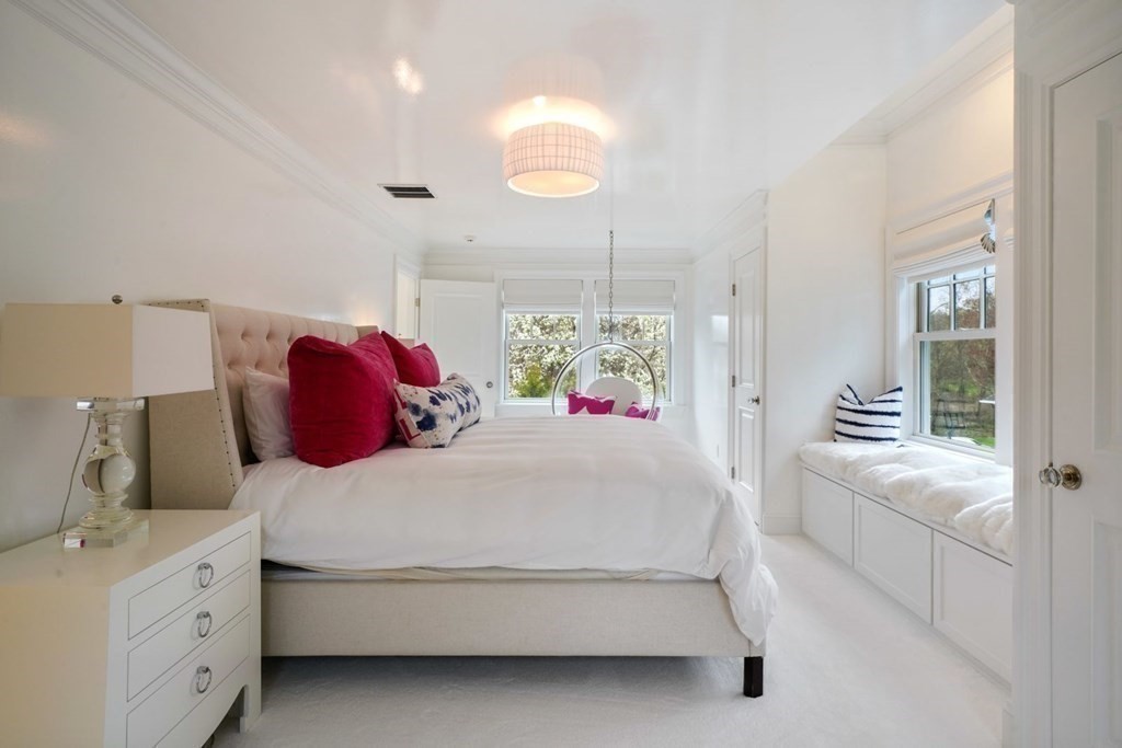 64 Cartwright Road Needham, MA 02492 - Photo 27 of 40 a bedroom with a bed and a chandelier