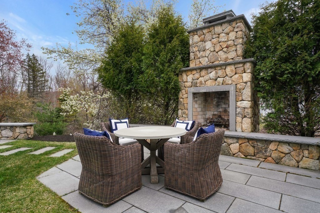 64 Cartwright Road Needham, MA 02492 - Photo 31 of 40 a view of a chairs and table in the back yard of the house
