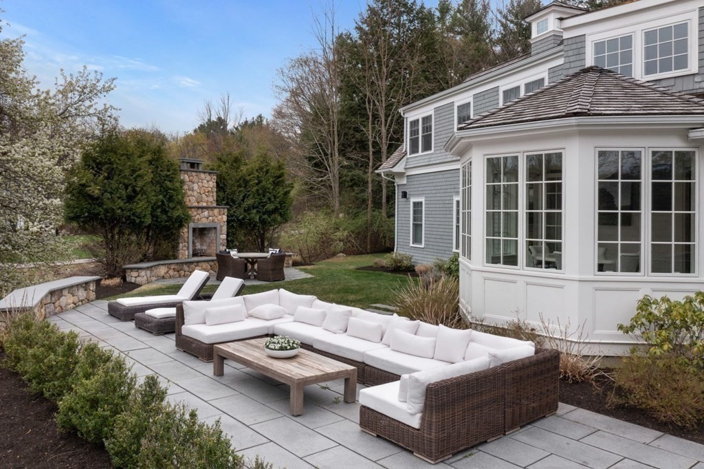 64 Cartwright Road Needham, MA 02492 - Photo 34 of 40 a view of a patio with couches table and chairs and potted plants