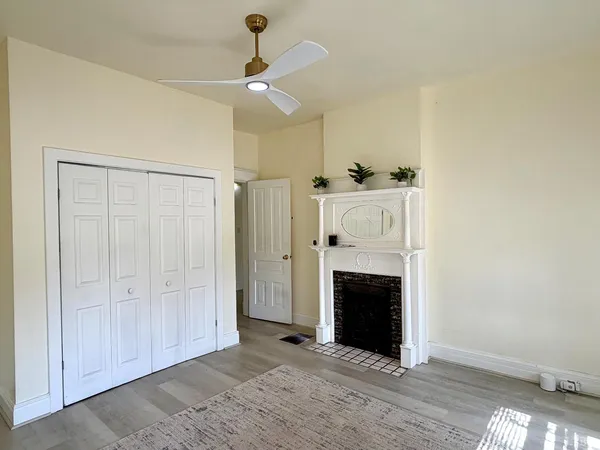 a living room with a fireplace and a wooden floor