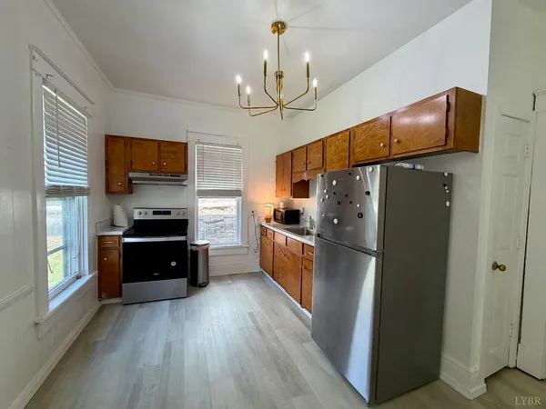 a kitchen with cabinets and appliances