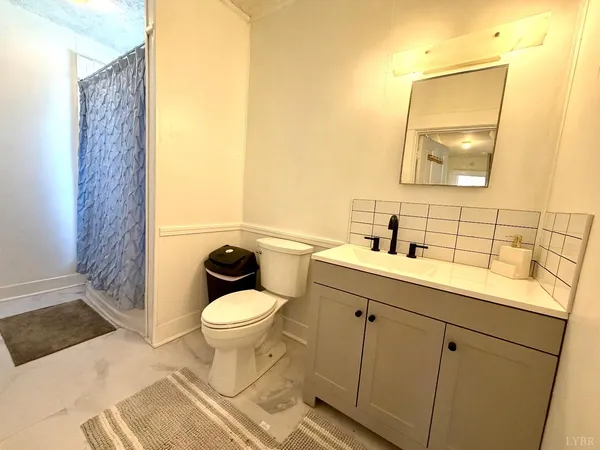 a view of kitchen with a sink a microwave and refrigerator