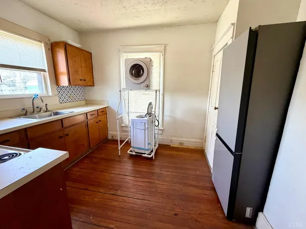 a kitchen with wooden cabinets and a stove top oven