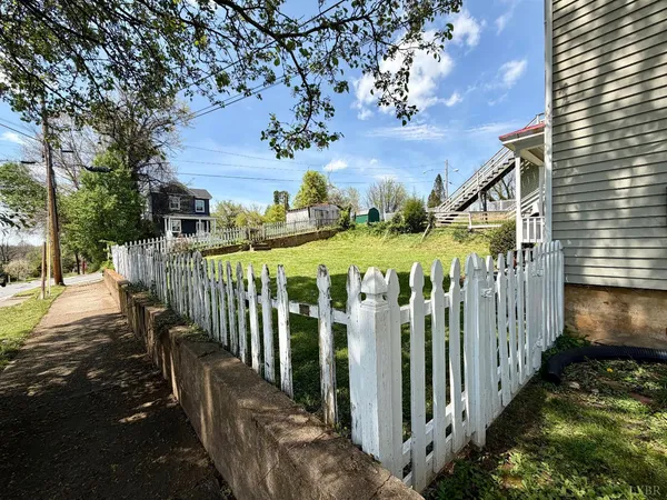 a view of a house with wooden fence