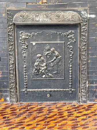 an empty room with windows fireplace and a sink