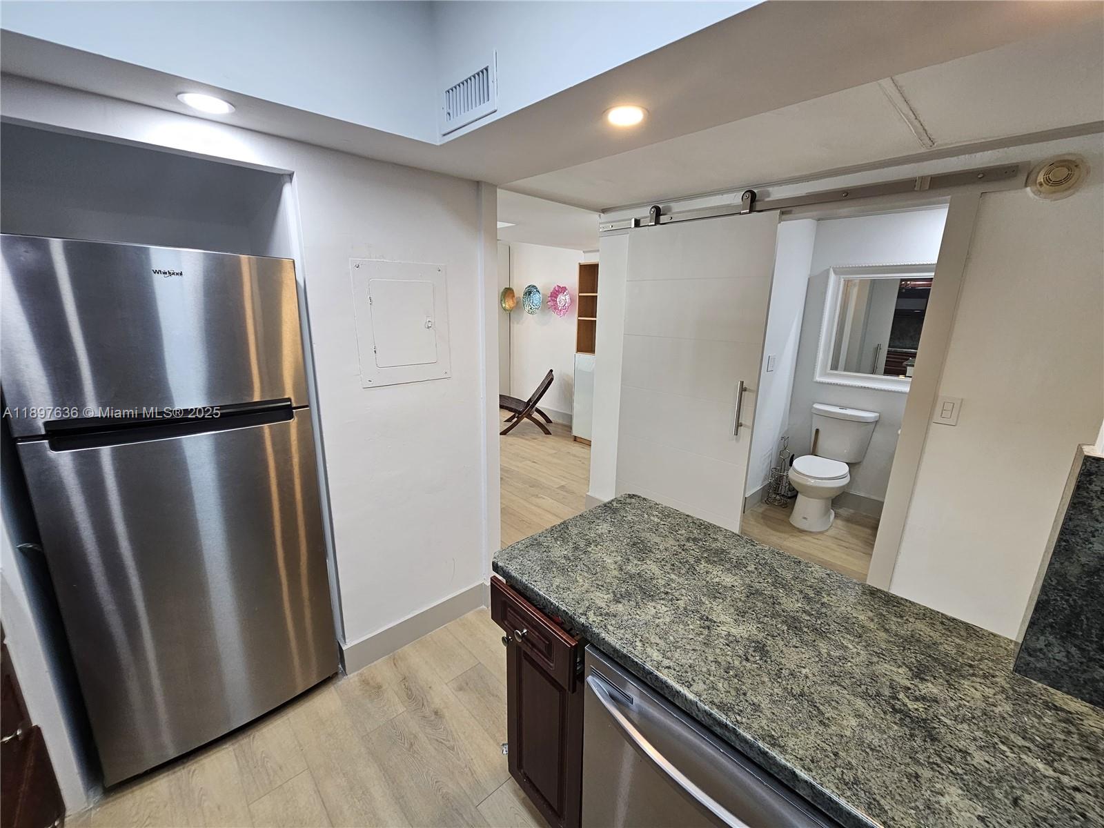 1408 Brickell Bay Drive, Unit 316 Miami, FL 33131 - Photo 14 of 19 a view of a refrigerator and wooden floor