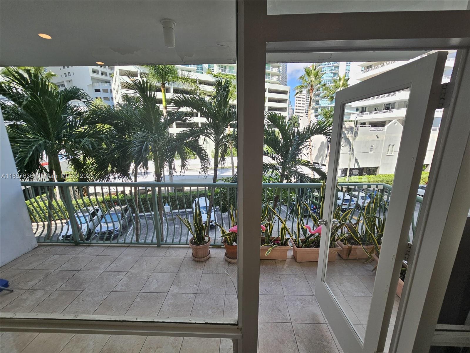 1408 Brickell Bay Drive, Unit 316 Miami, FL 33131 - Photo 19 of 19 a view of a porch with a table and chairs