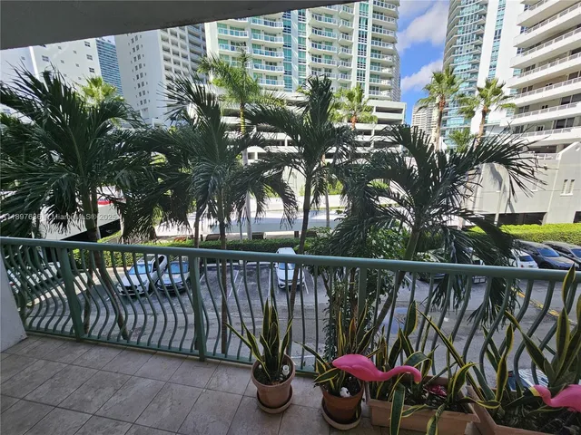 a view of a roof deck with wooden fence and potted plants