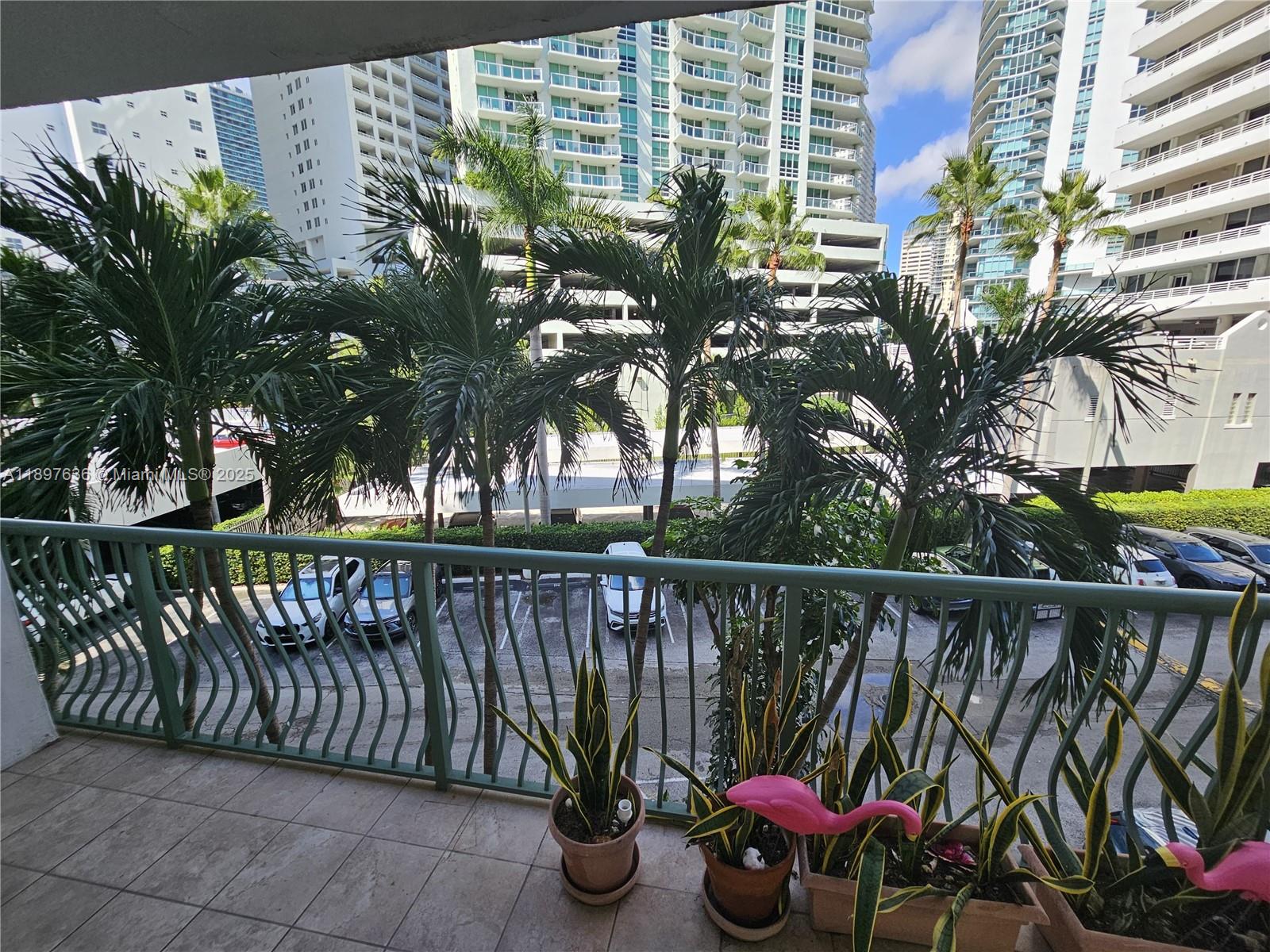 1408 Brickell Bay Drive, Unit 316 Miami, FL 33131 - Photo 4 of 19 a view of a roof deck with wooden fence and potted plants