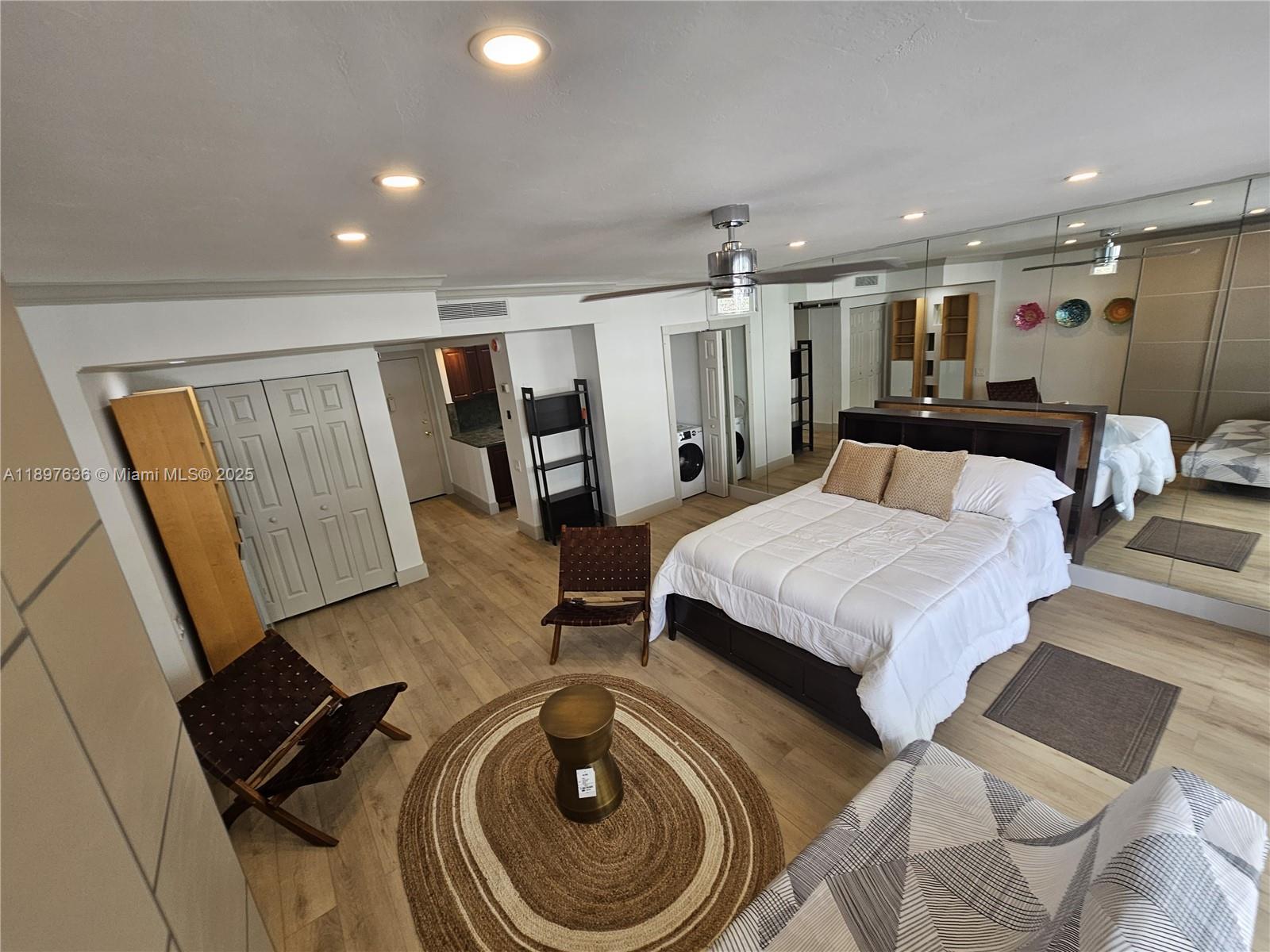 1408 Brickell Bay Drive, Unit 316 Miami, FL 33131 - Photo 6 of 19 a bedroom with a bed and a mirror