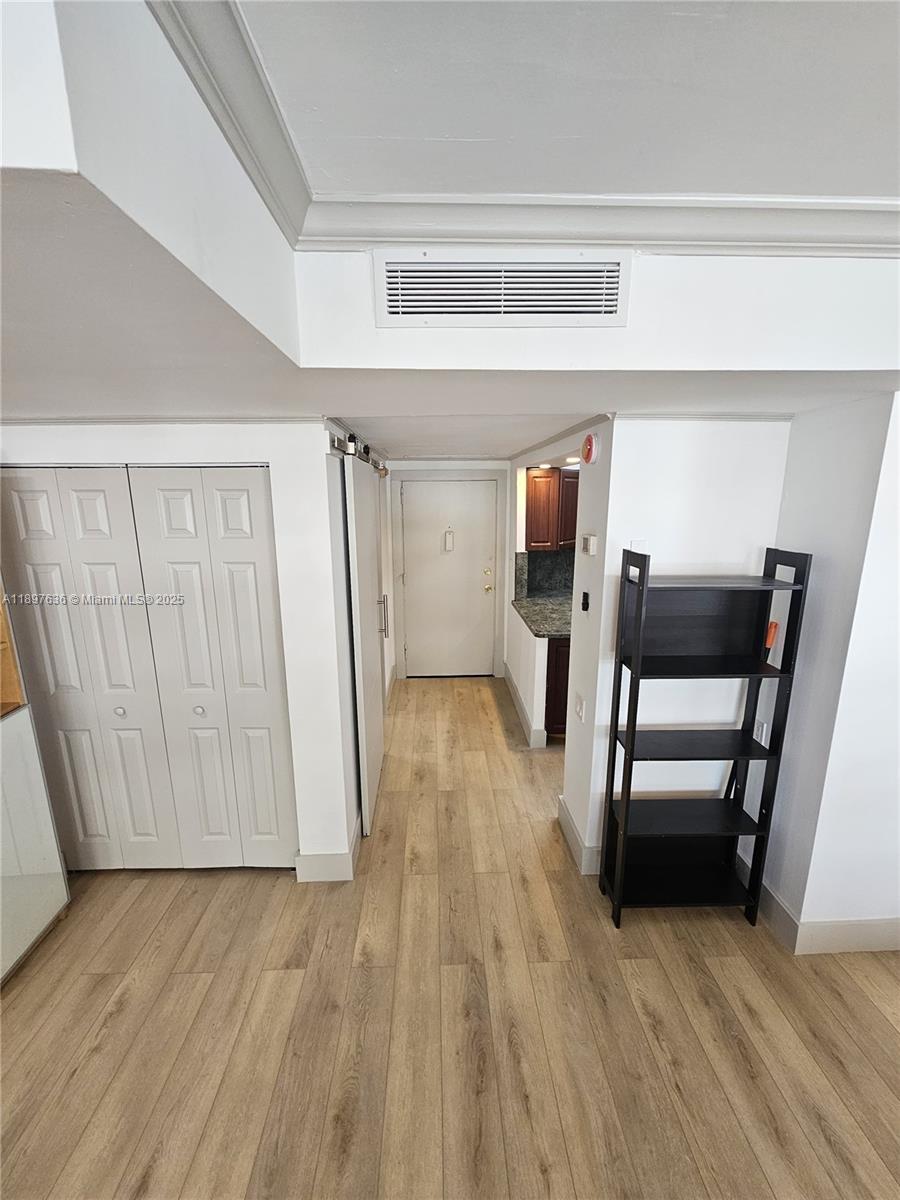 1408 Brickell Bay Drive, Unit 316 Miami, FL 33131 - Photo 8 of 19 a view of a livingroom with furniture and wooden floor