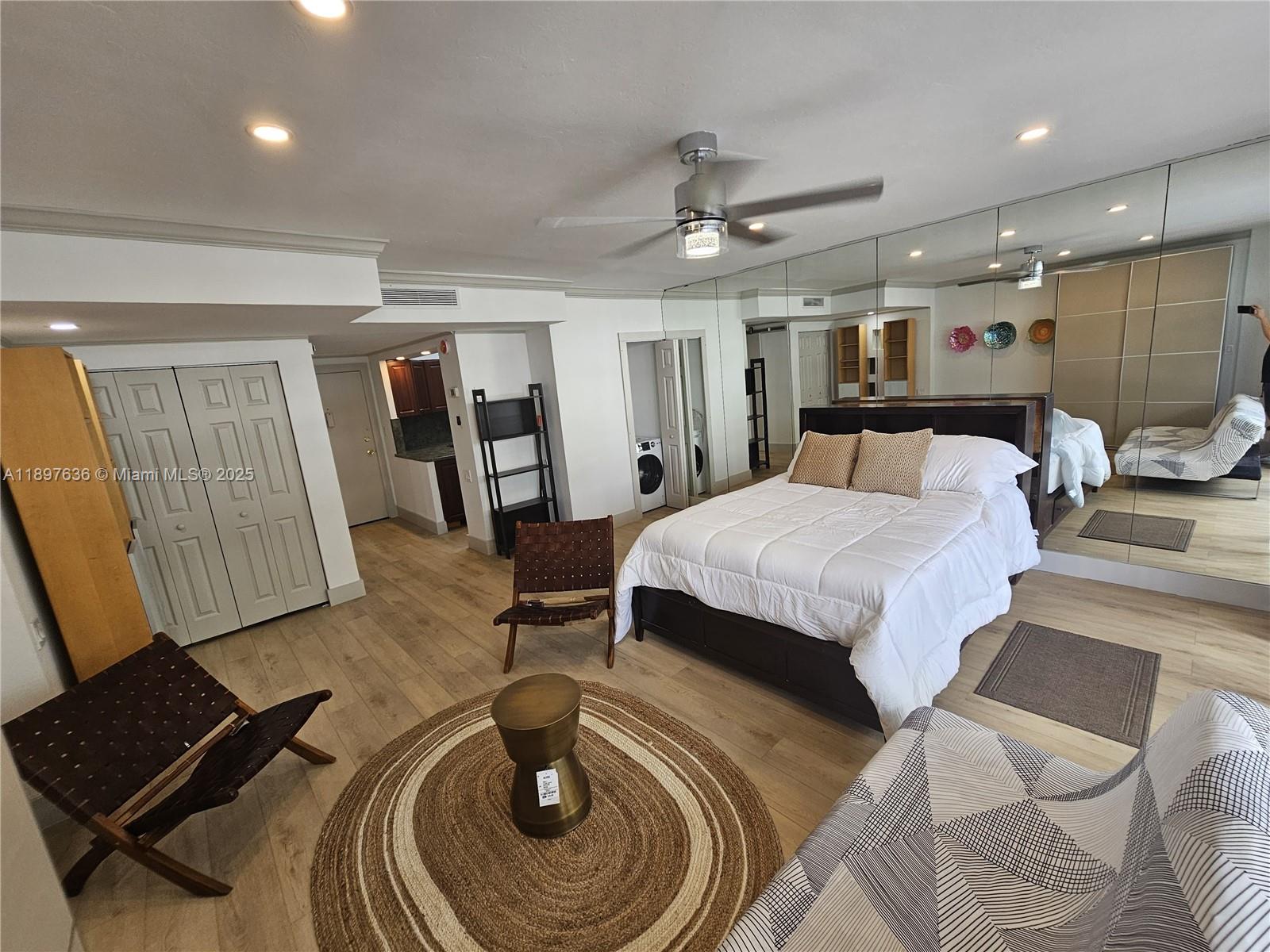 1408 Brickell Bay Drive, Unit 316 Miami, FL 33131 - Photo 9 of 19 a bedroom with a bed and wooden floor