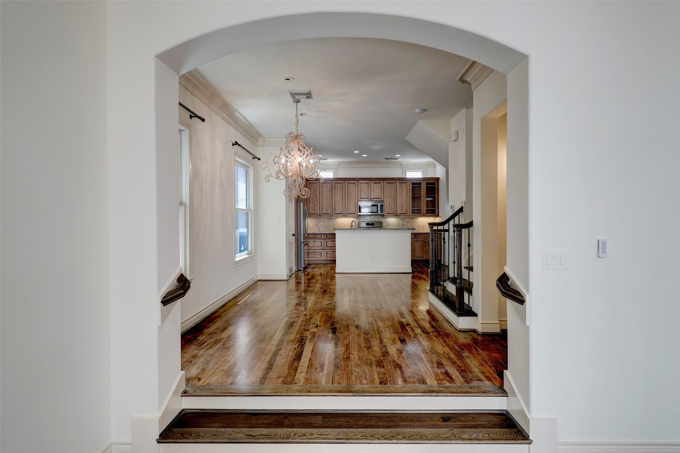 1436 Wichita Street Houston, TX 77004 - Photo 24 of 47 a living room with kitchen view and wooden floor