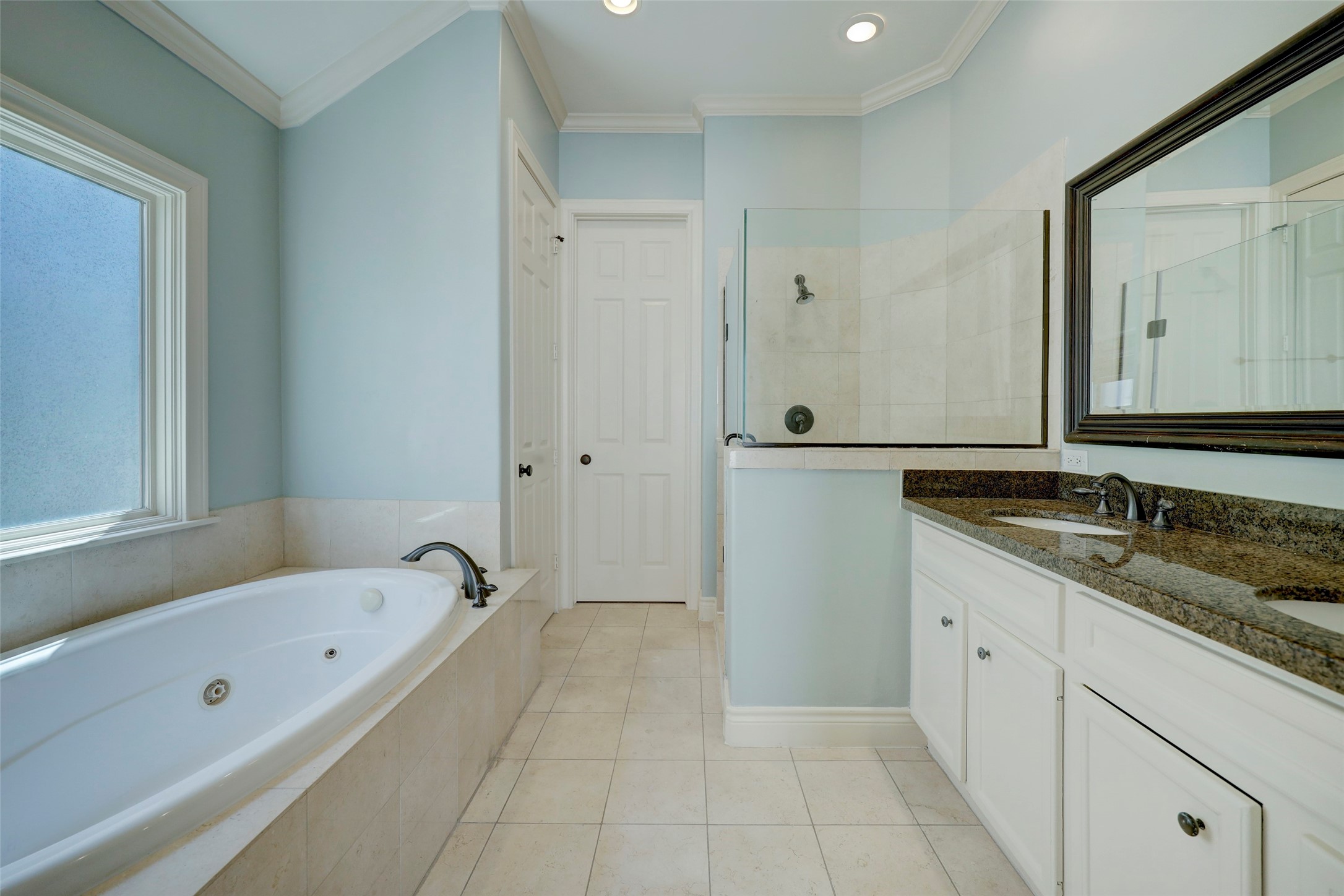 1436 Wichita Street Houston, TX 77004 - Photo 38 of 47 a bathroom with a granite countertop tub a sink and a mirror