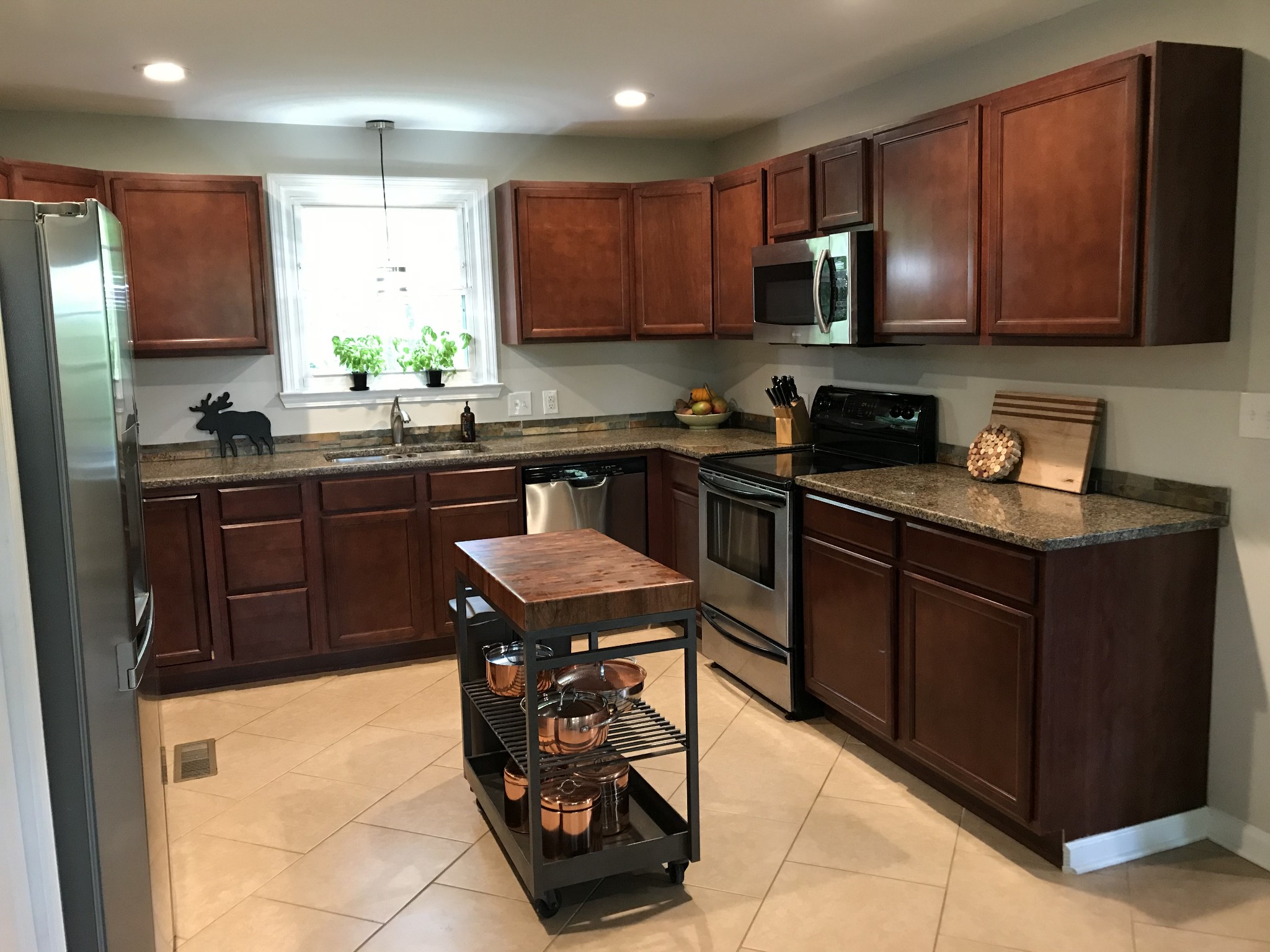 5534 Hickory Ridge Road Lebanon, TN 37090 - Photo 27 of 50 a kitchen with stainless steel appliances granite countertop a stove a sink dishwasher a microwave oven and a refrigerator