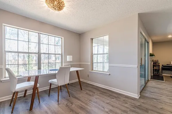a workspace room with furniture window and wooden floor