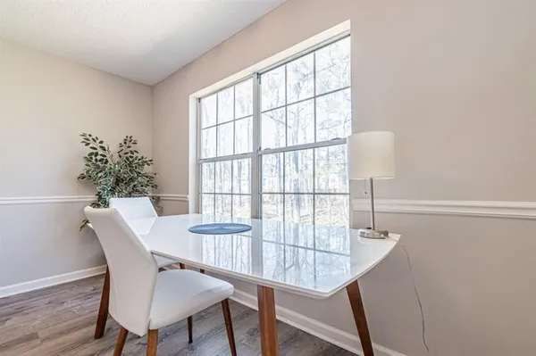 a view of a dining room with furniture window and wooden floor