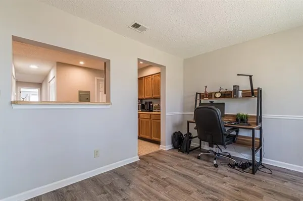 a view of a workspace with furniture and a window