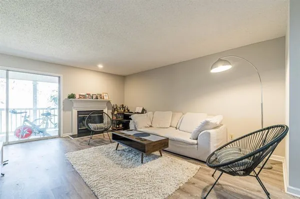 a living room with furniture a fireplace and a table
