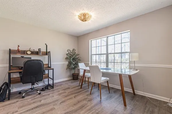 a view of a workspace with furniture and a window