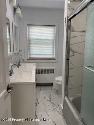 a bathroom with a sink a toilet and a bathtub