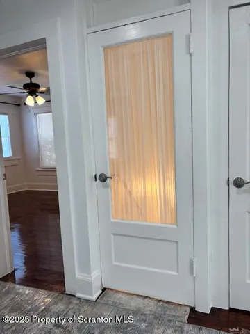 a view of an entryway with wooden floor