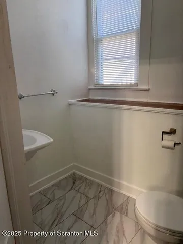 a utility room with a sink a chair and appliances