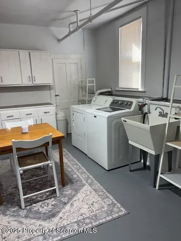 a kitchen with granite countertop a sink stove and cabinets