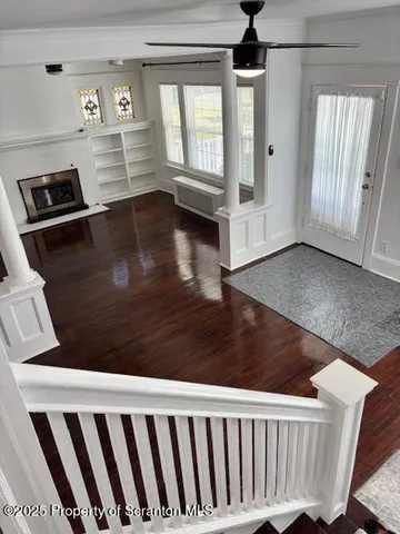 a view of a livingroom with wooden floor and window