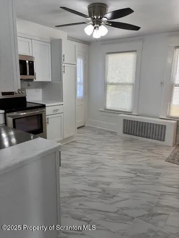 a kitchen with stainless steel appliances a refrigerator and a stove top oven