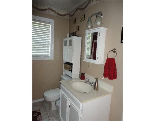 4209 Harry Street Corpus Christi, TX 78411 - Photo 6 of 10 a bathroom with a toilet sink and mirror