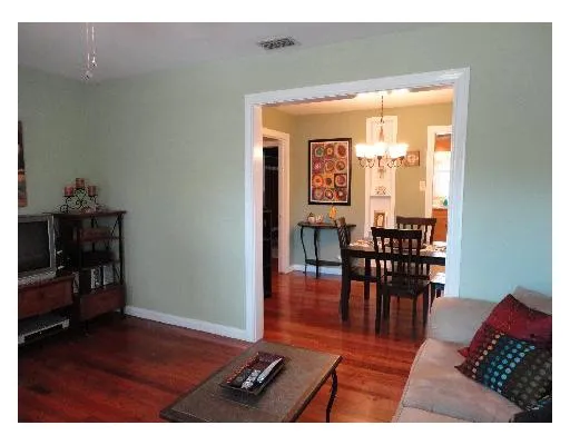 a view of a dining room with furniture and a potted plant