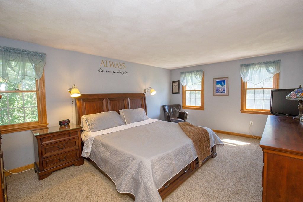 19 Gov Doherty Road Billerica, MA 01821 - Photo 16 of 28 a bedroom with a bed and wooden floor