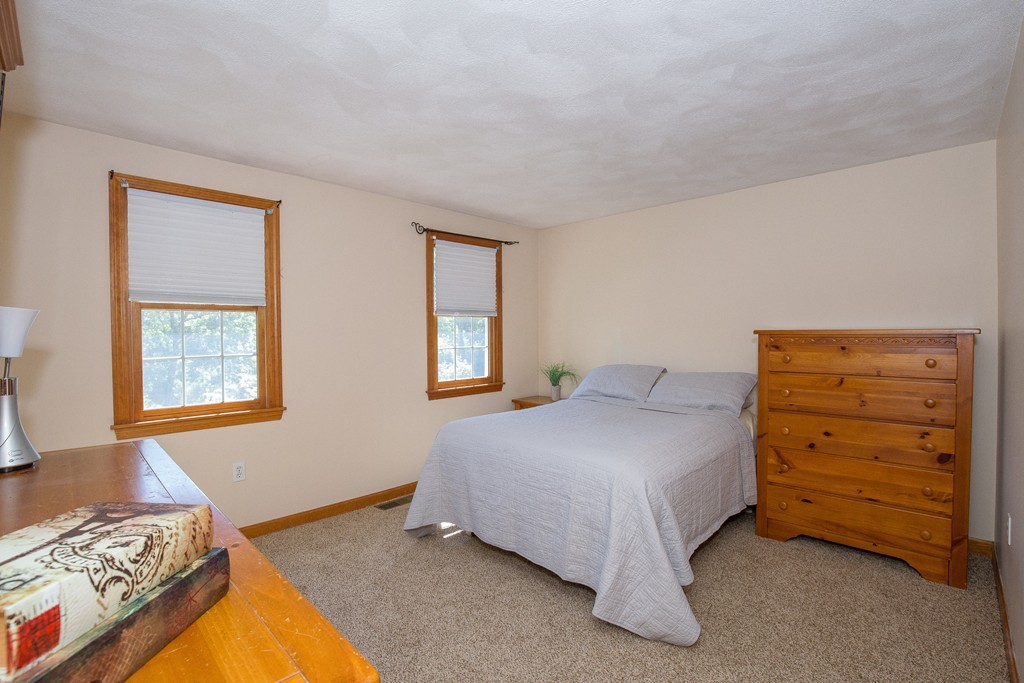 19 Gov Doherty Road Billerica, MA 01821 - Photo 20 of 28 a bedroom with a bed and two windows