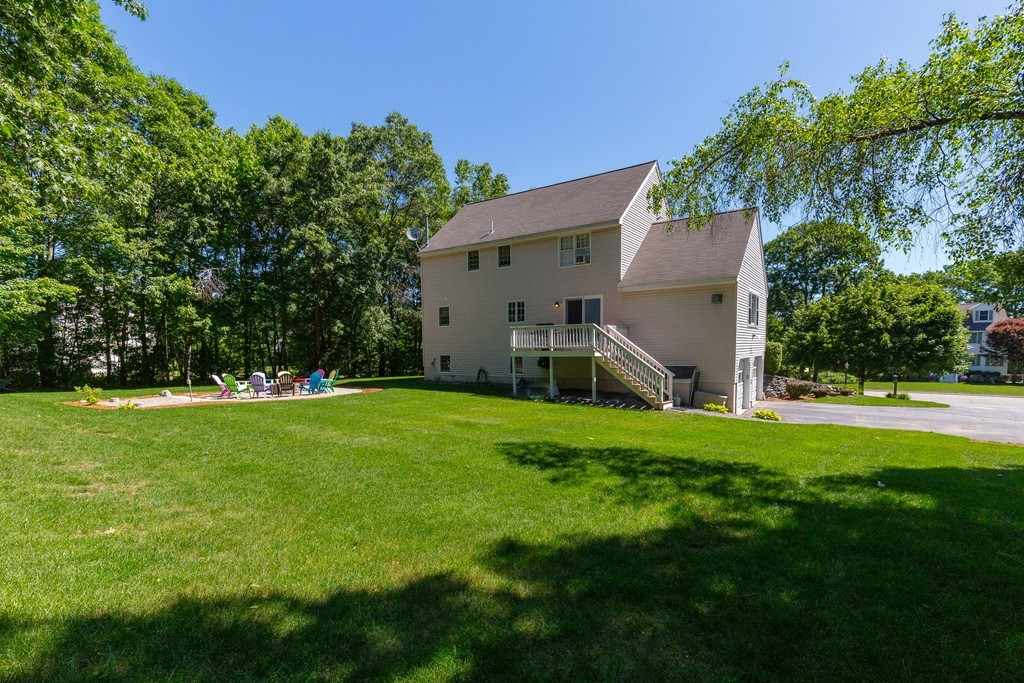 19 Gov Doherty Road Billerica, MA 01821 - Photo 2 of 28 a view of a backyard with table and chairs and potted plants and large trees