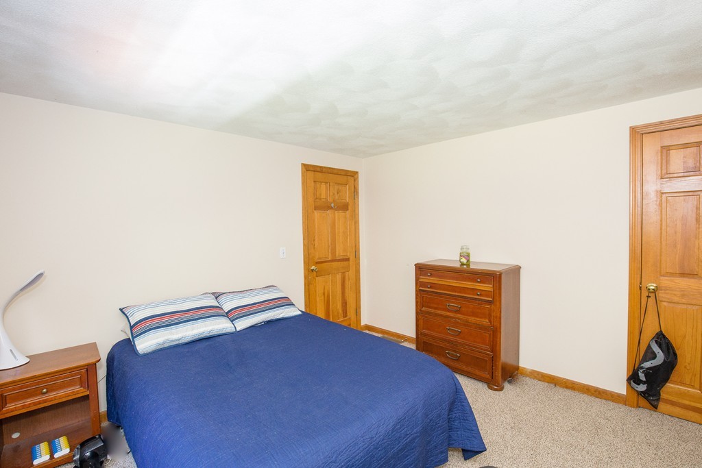 19 Gov Doherty Road Billerica, MA 01821 - Photo 21 of 28 a bedroom with a bed and cabinets