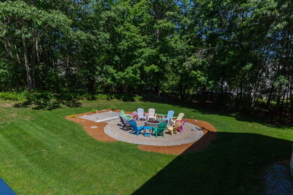 19 Gov Doherty Road Billerica, MA 01821 - Photo 26 of 28 a view of a backyard with table and chairs potted plants and large tree