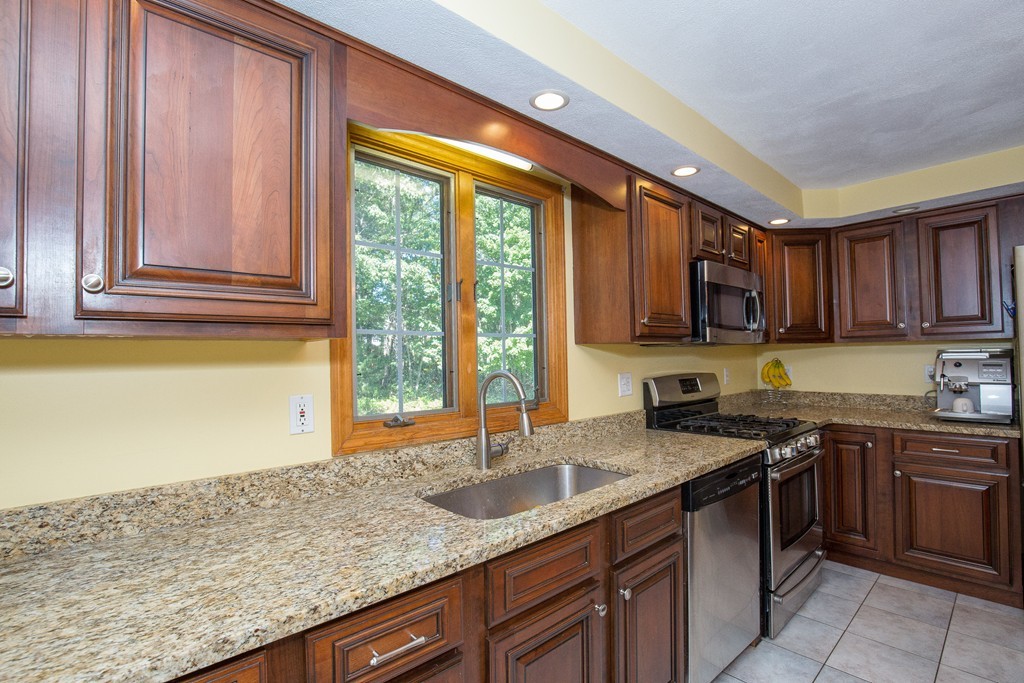 19 Gov Doherty Road Billerica, MA 01821 - Photo 4 of 28 a kitchen with stainless steel appliances granite countertop a sink stove and cabinets