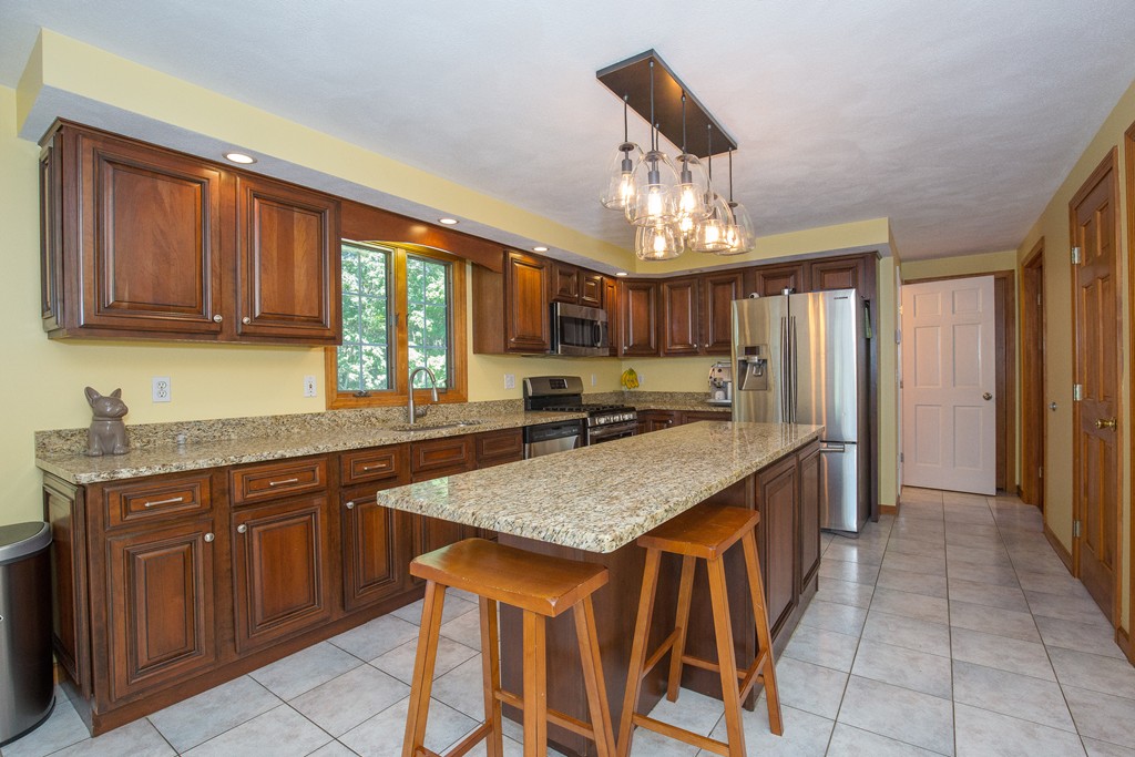 19 Gov Doherty Road Billerica, MA 01821 - Photo 5 of 28 a kitchen with stainless steel appliances granite countertop wooden cabinets a center island and stainless steel appliances