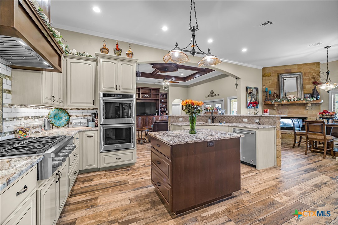 254 Sendera Loop Victoria, TX 77904 - Photo 21 of 48 a kitchen with stainless steel appliances granite countertop a stove and a refrigerator