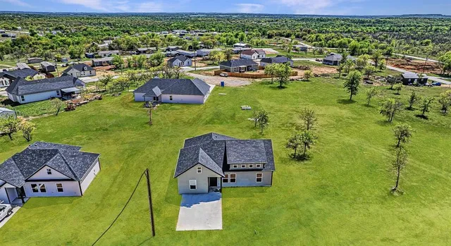 an aerial view of residential houses with outdoor space