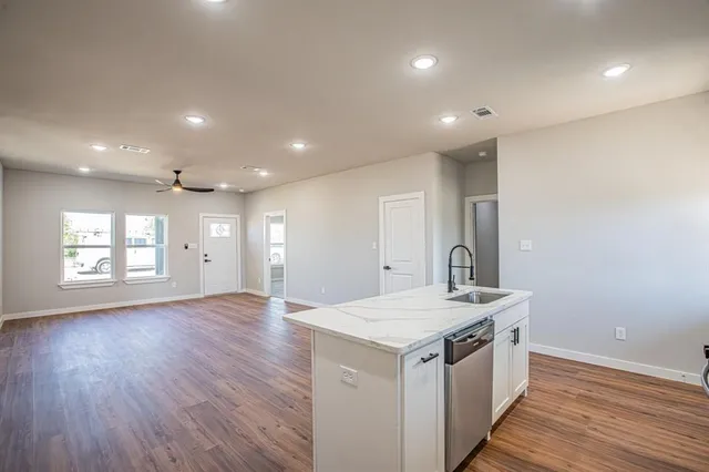 a view of a kitchen cabinets a sink and wooden floor